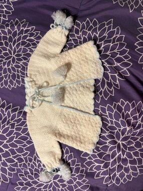 Hand knitted baby jacket, sparkly white with blue accents